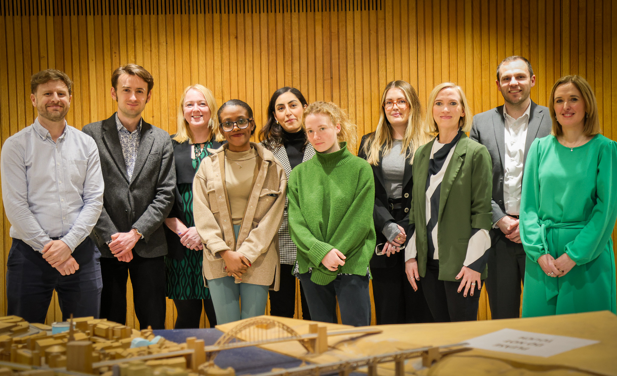 A row of professional people looking straight into the camera