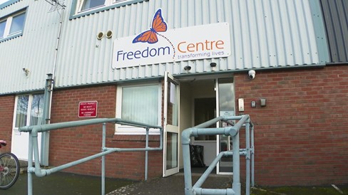 The front of the Freedom Centre building with a sign saying Freedom Centre: transforming lives with a butterfly logo