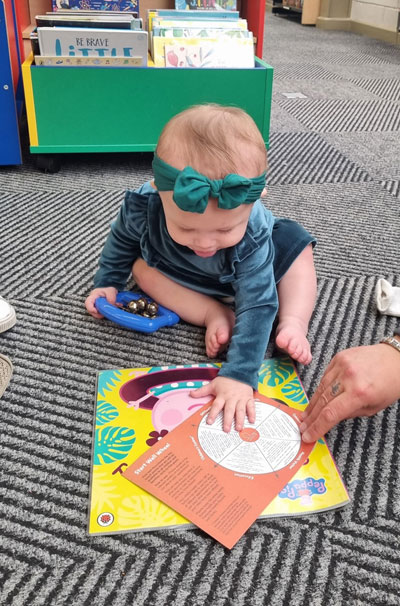Harper with the Start Well Wheel at Parr Library Read and Rhyme Time