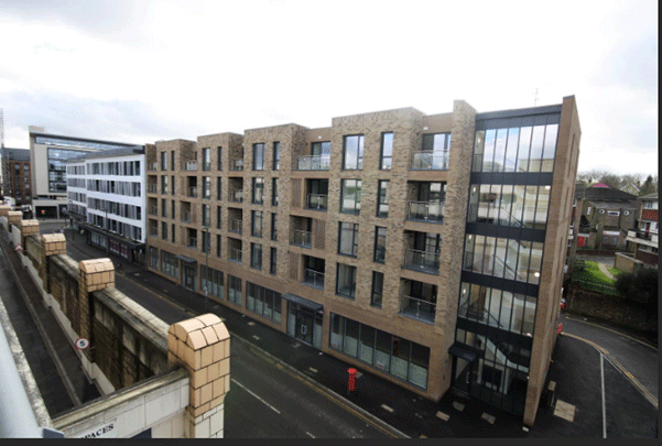 A large new build complex with light brown bricks and modern windows