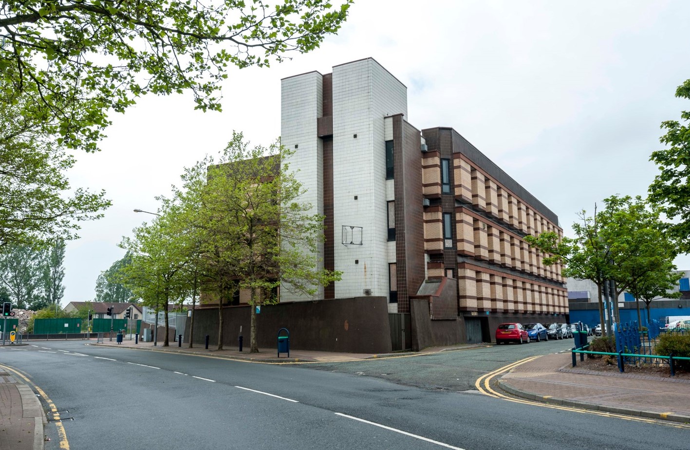 Webster House before it was demolished, three storeys high and standing by a junction