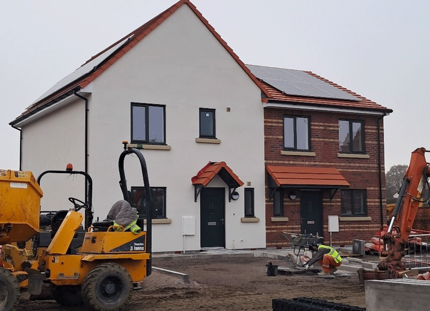 A new home development in the late stages of being built.