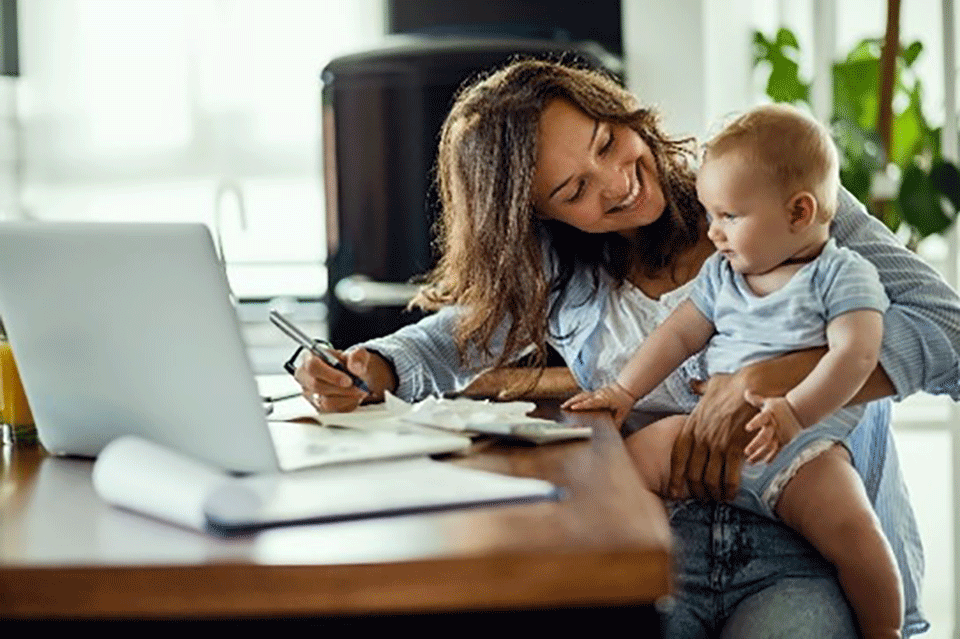 Mother smiling at her baby on a table
