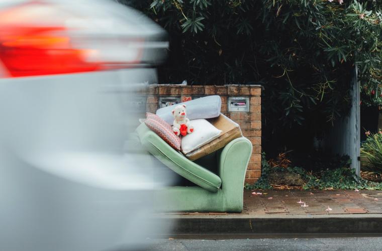 photo of flytipping - sofa and toys by side of the road
