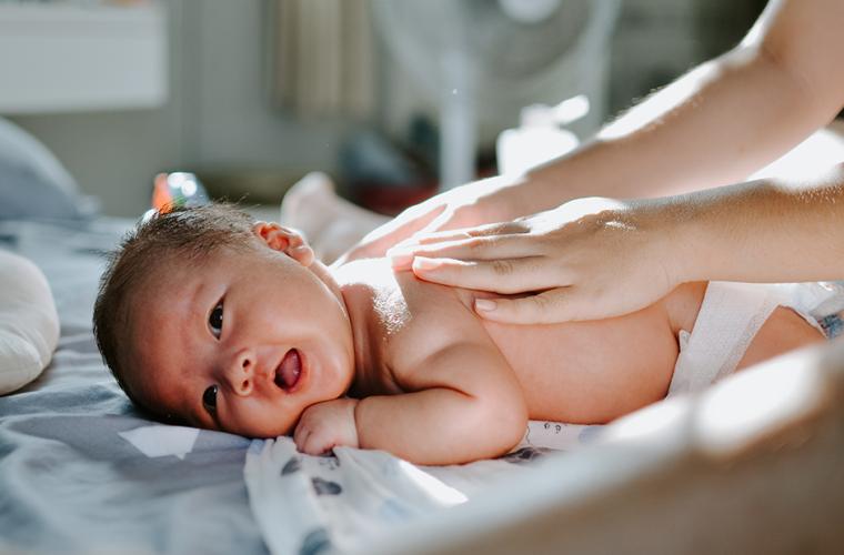 Baby at home receiving massage