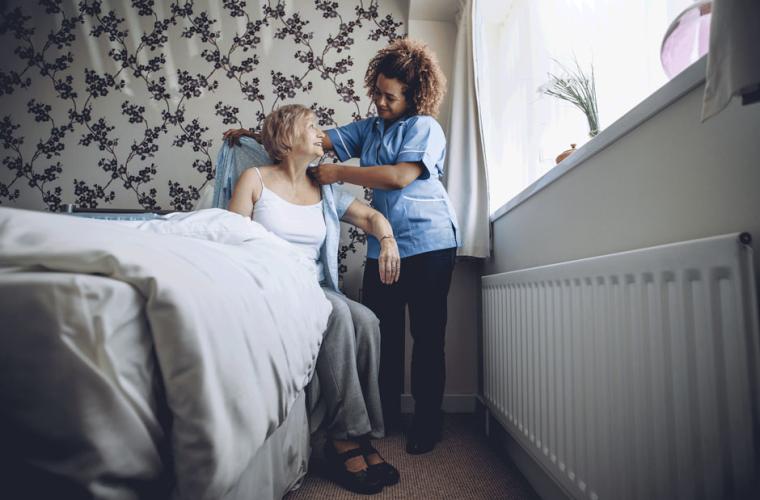Carer helping an old woman
