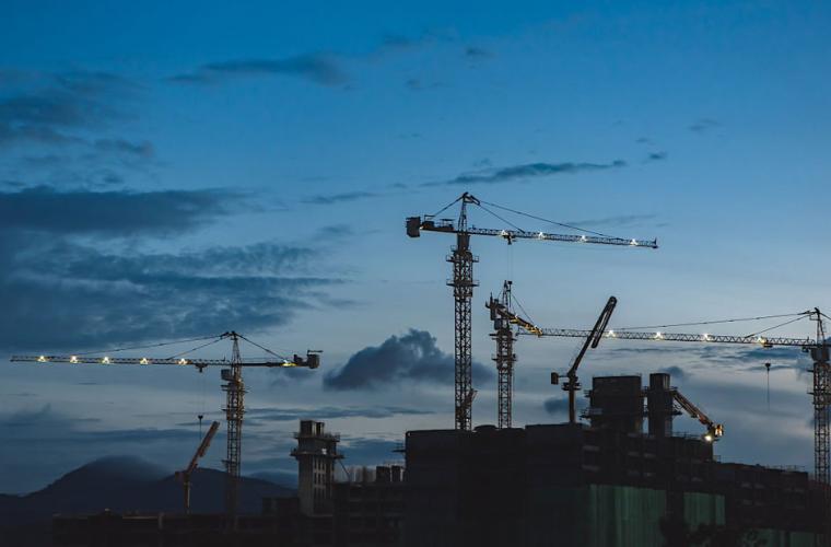 Construction site in the distance with cranes stationary