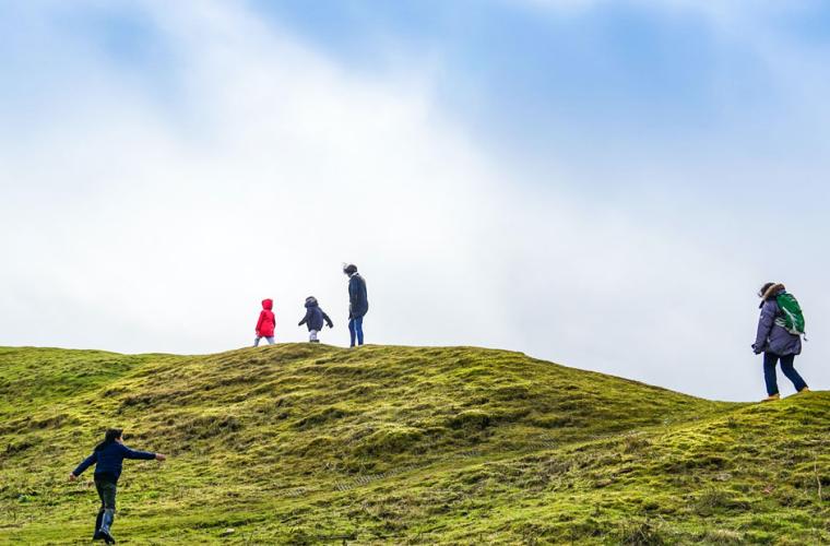 Family walking on a hill 941 x 641px