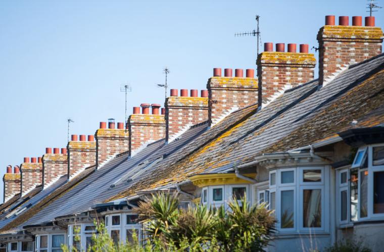 photo of top half of a row of red brick houses 