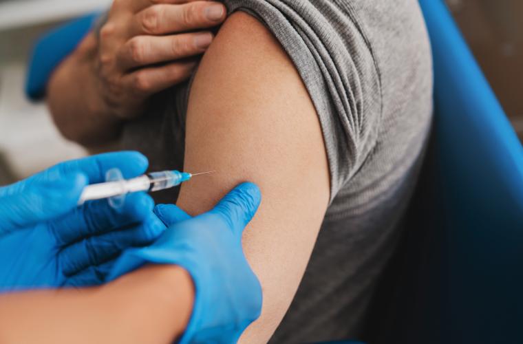 A injection being administered into an arm