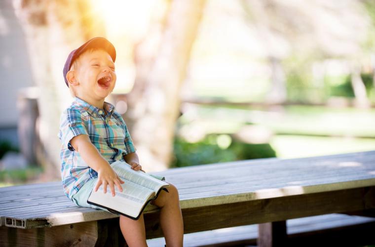 Little boy sitting on a bench