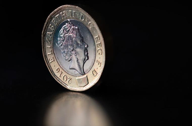 Pound coin on black background