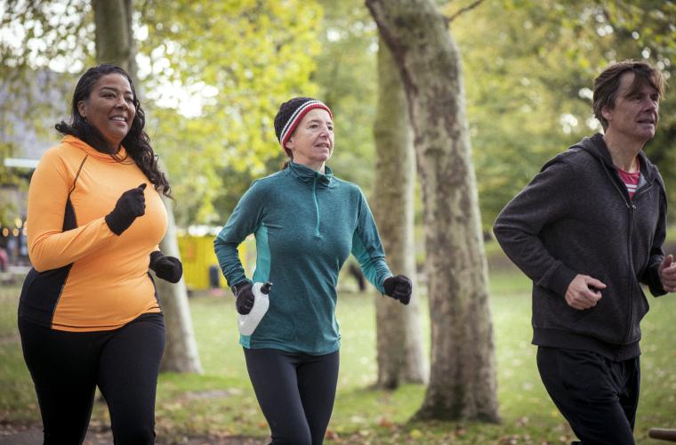 Group of people running in a park during the day time. 