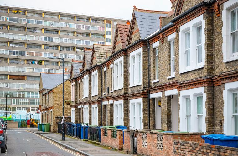 Row of terraced houses with block of flats in background