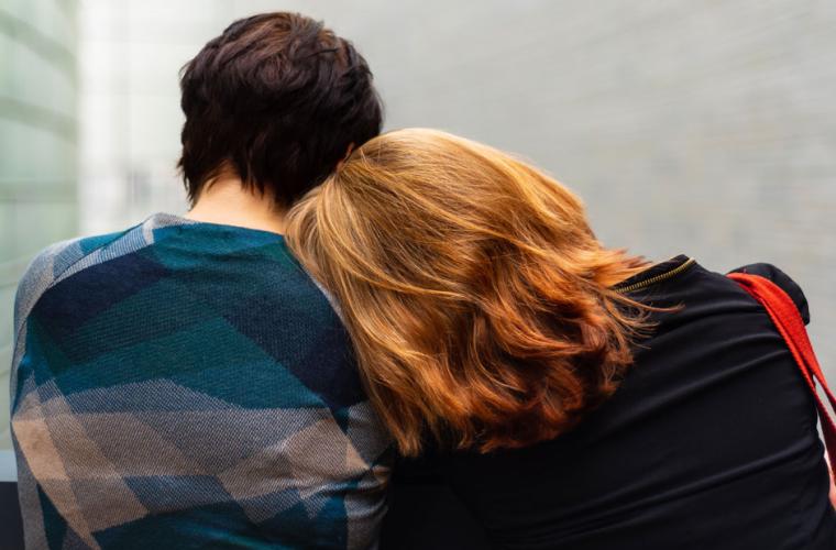 Woman leaning her head on another woman's shoulder