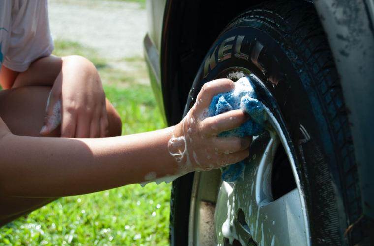 Young person washing a car