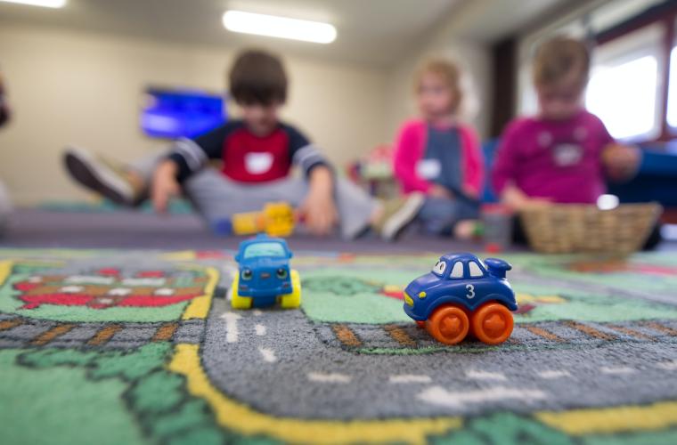 Young children playing together in nursery
