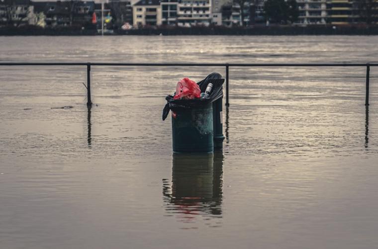 park flooded only black bin with rubbish and railings above water level showing