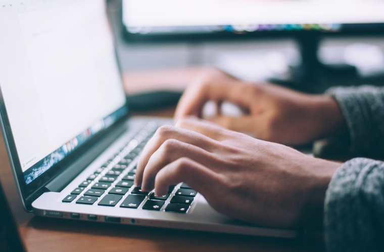 Someone typing on a laptop