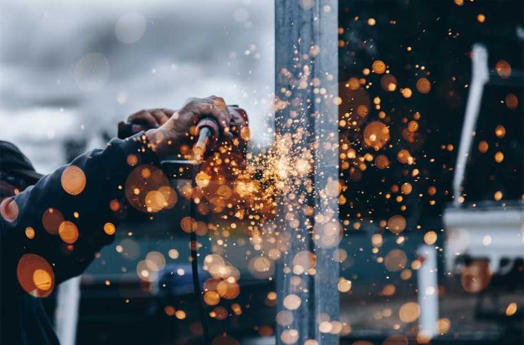 male hands welding sparks in the air