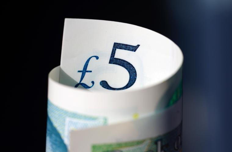 five pound notes rolled up