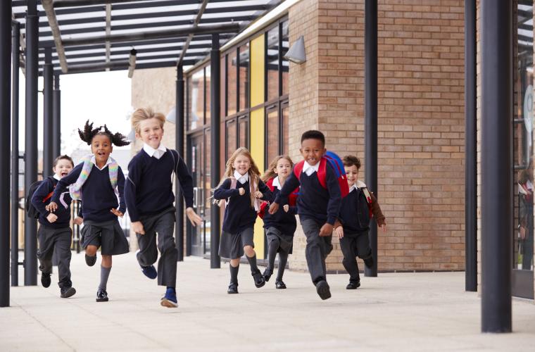 Primary school children running at school