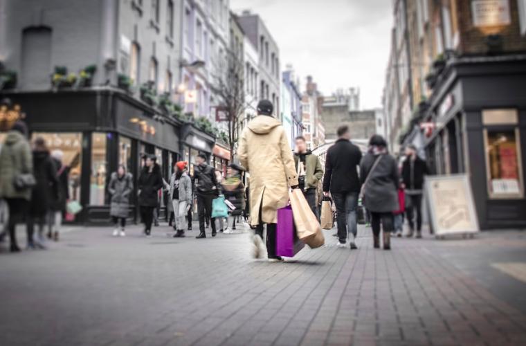 Shoppers walking through a bustling high street 1000x500