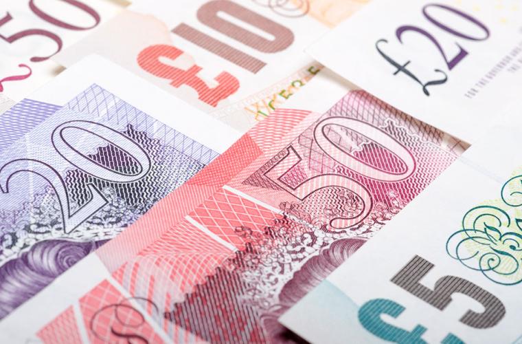 Various pound notes in a grid pattern
