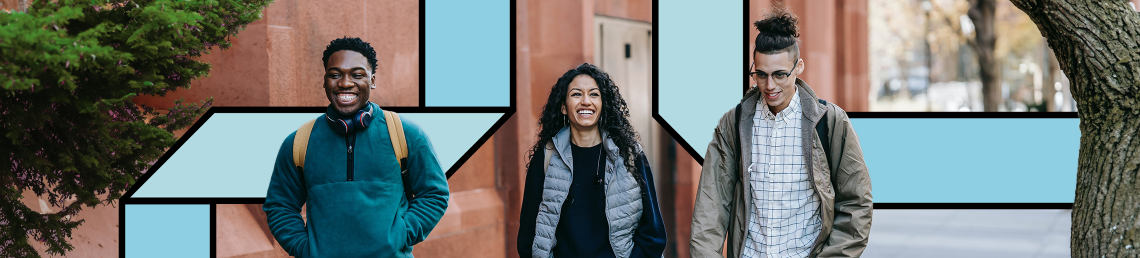 Three graduates walking down the street with a building behind them