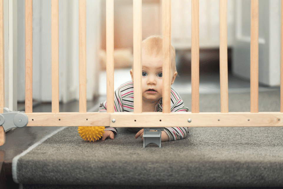 Baby crawling towards a safety gate