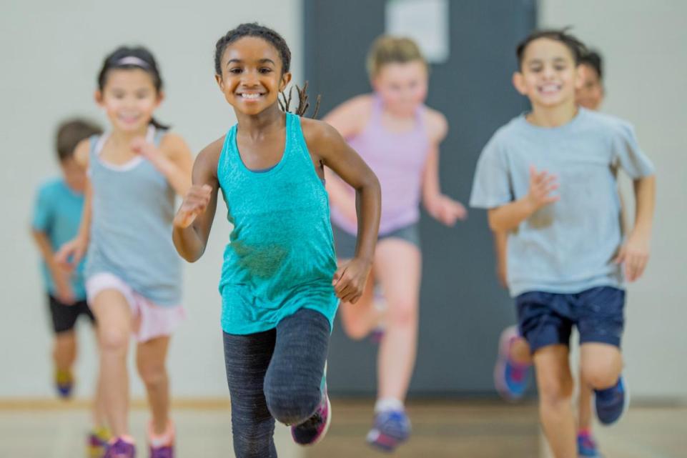 young child running in school hall 