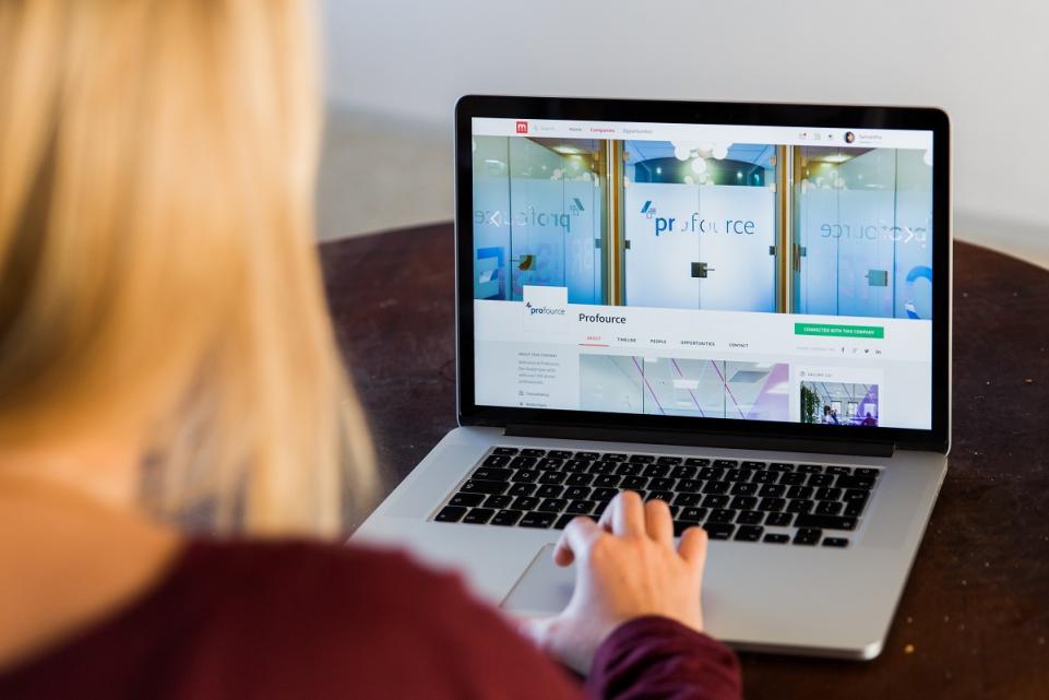 A woman on a laptop searching for a job